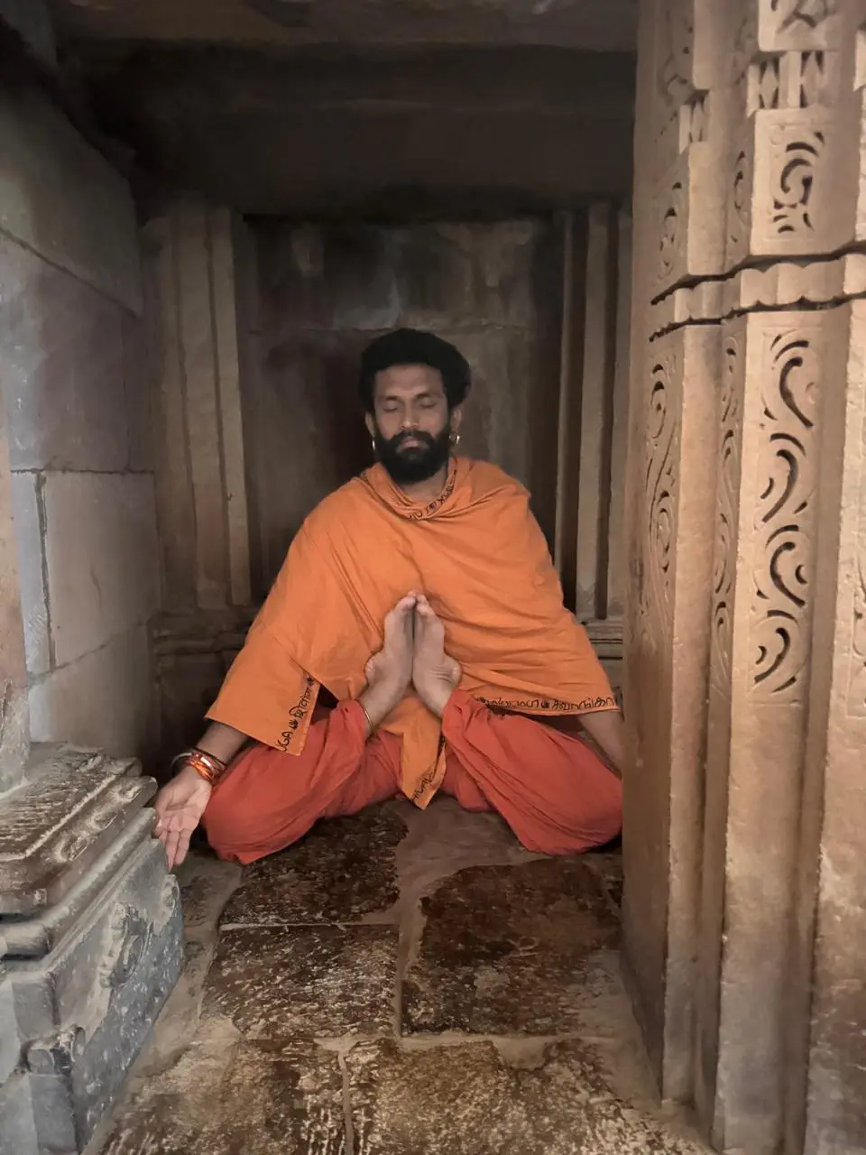 A practitioner seated in deep meditation, evoking the stillness of Kandasana